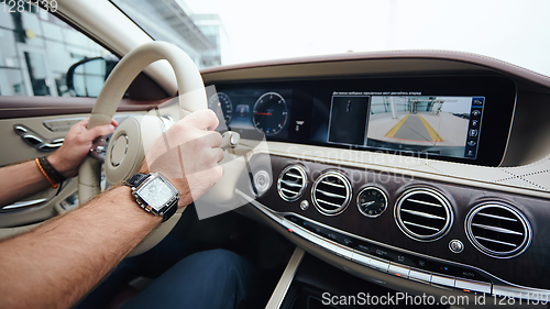 Image of Man sitting and driving in the car.