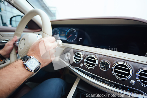 Image of Man sitting and driving in the car.