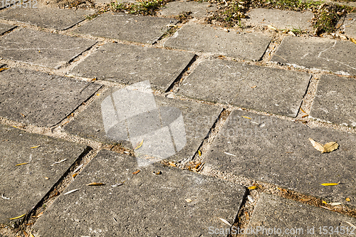 Image of old large tiles on the road