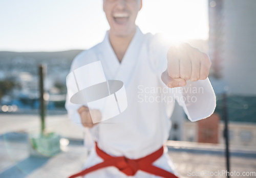 Image of Karate, fitness and fight with a sports man in gi, training in the city on a blurred background. Exercise, discipline or power with a male athlete during a self defense workout for health closeup