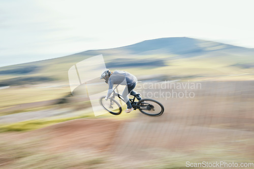 Image of Sports, energy and man riding a bike in nature training for race, marathon or competition. Fitness, blur motion and male athlete biker practicing for an outdoor cardio exercise, adventure or workout.