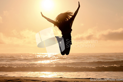 Image of Freedom, jump and sunset with woman at beach for travel, celebration and winner. Success, summer and silhouette with person jumping in nature for inspiration, energy and purpose with mockup space