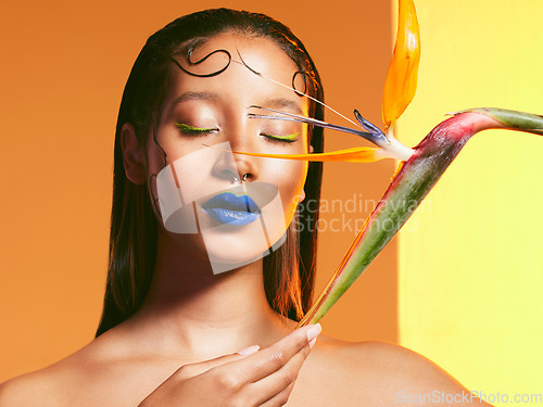 Image of Makeup, flowers and face of woman with cosmetics in studio for salon, eye shadow and beauty. Aesthetic, cosmetology and female person with blue lipstick and plant for glamour, luxury style and glow