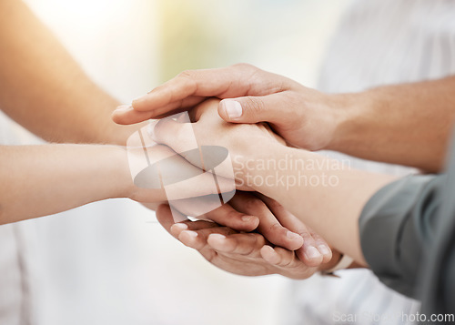 Image of Collaboration, support and business people with a pile of hands in a huddle as a team for community, solidarity or unity. Teamwork, trust or motivation with a group of colleagues standing in a circle