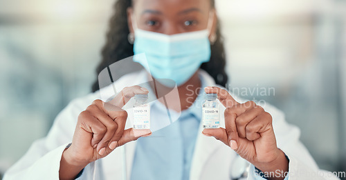 Image of Covid 19, doctor hands and black woman with vaccine vial for virus or corona. Bottle, medical professional or portrait of person with vaccination mask, medicine or pharmaceutical drugs for healthcare