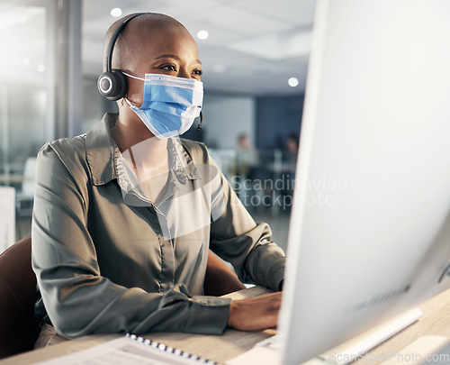 Image of Face mask, call center and a woman at computer with headset for safety compliance and health. African female agent at pc for customer service, help desk or crm with protection from covid or bacteria