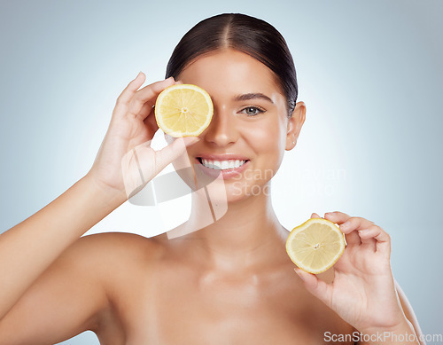 Image of Face, skincare and smile of woman with lemon in studio isolated on a white background. Portrait, natural and female model with fruit for vitamin c, nutrition or healthy diet, wellness or cosmetics.