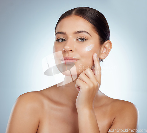 Image of Skincare, face and woman with cream in studio isolated on a white background. Portrait, dermatology lotion and female model apply beauty cosmetics, sunscreen or moisturizer product for skin health.