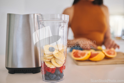 Image of Fruit, smoothie and closeup with woman and blender in kitchen for gut health, diet and breakfast. Wellness, detox and nutrition with female person at home for cooking, juice and weight loss milkshake