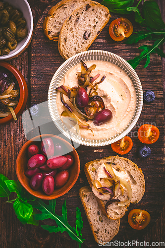 Image of Whipped feta cheese dip with garlic, olives, lemon and caramelized onions. 