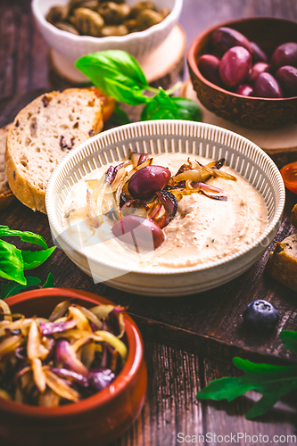 Image of Whipped feta cheese dip with garlic, olives, lemon and caramelized onions. 