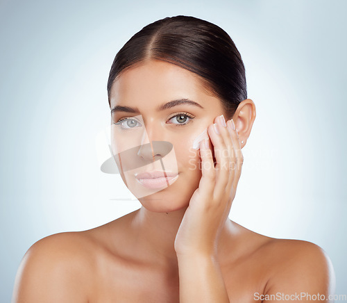 Image of Skincare, face and beauty of woman with lotion in studio isolated on a white background. Portrait, dermatology cream and female model apply cosmetics, sunscreen or moisturizer product for skin health