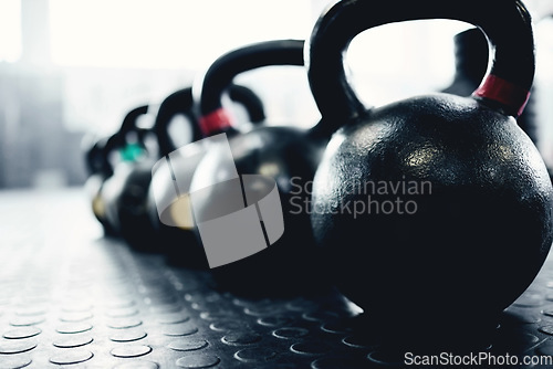 Image of Fitness, weights and kettlebell on floor of gym for workout, strong and exercise. Metal, iron and performance with sports equipment in training center for weightlifting, wellness and challenge