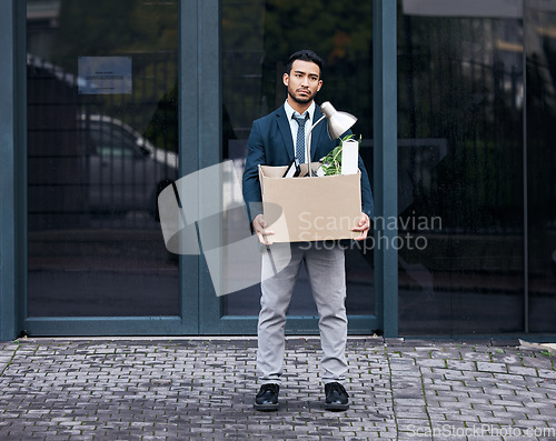 Image of Depression, box and dismissal with a business man carrying while walking outdoor in the city. Financial crisis, economy unemployment and jobless with a fired male employee looking sad in the cbd