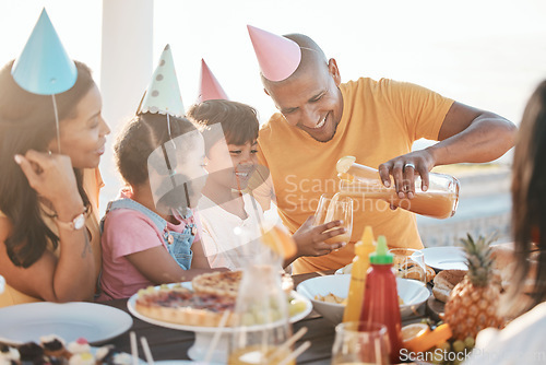 Image of Birthday, parents and children with juice by beach for event, celebration and outdoor party together. Family, social gathering and mother, dad and kids at picnic with cake, presents and eating food