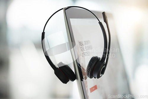 Image of Technology, call center agent headset and computer for online communication with a lens flare. Customer service or crm equipment, telemarketing or consulting and tech support or sales at workplace