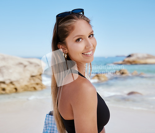 Image of Woman, portrait and smile at beach with travel, summer tropical vacation in Mexico with tourism and adventure. Female person is happy, relax on holiday with journey to the ocean and seaside nature