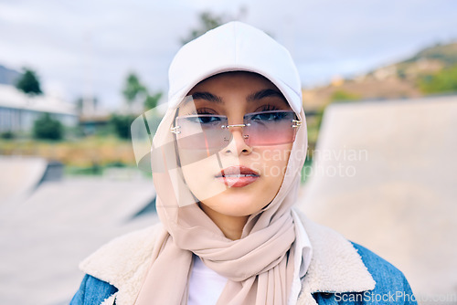 Image of Portrait, fashion or sunglasses with a muslim woman outdoor in a cap and scarf for contemporary style. Islam, faith and hijab with a trendy young arab female person posing outside in modern eyewear