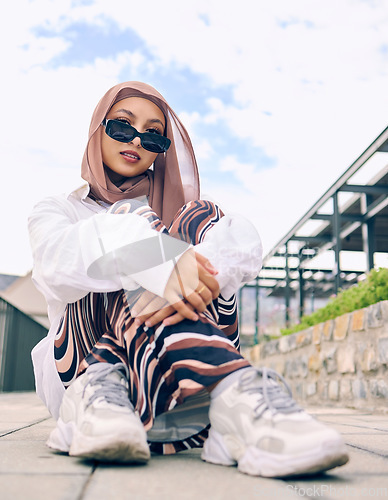 Image of Portrait, fashion or hijab with a muslim woman outdoor in sunglasses and a scarf for contemporary style. Islam, faith or religion with a trendy young arab person posing outside in modern clothing