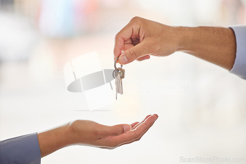 Image of Hands, realtor and agent giving keys to customer after moving into new home. Property, real estate and handing over key to owner for sale, loan or mortgage investment in apartment, house and mockup.