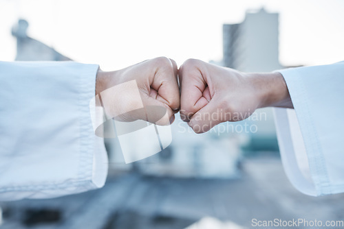 Image of Motivation, support and fist bump for karate in the city for fitness, training or learning. Deal, goal and together hands of people in creative sports or martial arts with power and urban competition