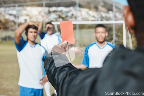 Image of Sports team, red card and soccer referee outdoor on field for game foul, mistake or compliance. Football player, athlete club and paper in person hand for sport warning, penalty rules or dismissal