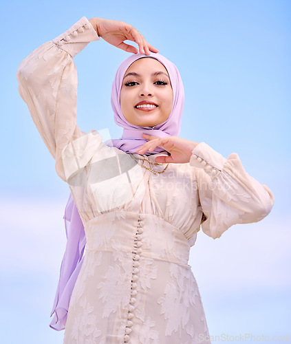 Image of Portrait, fashion or religion with a happy saudi woman on a blue sky background in a scarf for style. Islam, faith or hijab with a trendy young muslim person posing outdoor in contemporary clothes