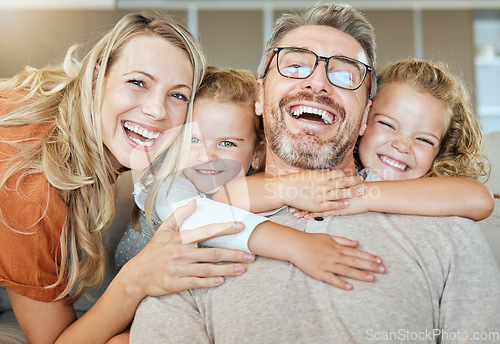 Image of Parents, portrait and couch with hug, kids and smile with love, bonding and care in family home together. Father, mother and daughters with happiness, embrace and relax on living room sofa in house