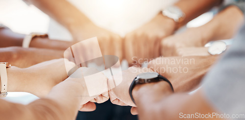 Image of Group, circle and fist bump with team building closeup, community or collaboration for goals in office. Business people, synergy and productivity with solidarity, agreement or networking in workplace