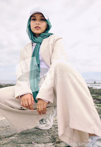 Image of Portrait, fashion or religion with a muslim woman outdoor in a cap and scarf for contemporary style. Islam, faith and hijab with a trendy young arab female person posing outside in modern clothes