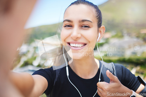 Image of Runner woman, mountain selfie and portrait for energy, smile and fitness training for wellness on social media. Girl, influencer and profile picture with ocean, cityscape and thumbs up with music