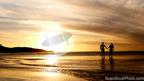 Image of Couple, sunset and walk by sea with space for mockup in summer sunshine with love, care and bond on holiday, Man, woman and holding hands with sky background, beach and clouds on romantic vacation
