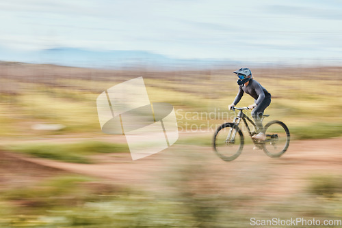 Image of Fitness, adrenaline and man riding a bike in nature training for a race, marathon or competition. Sports, motion and male athlete biker practicing for an outdoor cardio exercise, adventure or workout