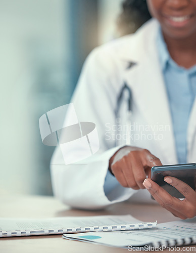 Image of Phone, doctor and hands of black woman texting for telehealth, healthcare or research in hospital. Smartphone, medical professional or happy person with online consultation, reading email or wellness