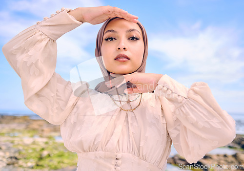 Image of Portrait, hands or fashion with a muslim woman outdoor in a scarf for religion or contemporary style. Saudi, face and hijab with a trendy young islam female person posing outside in modern clothes