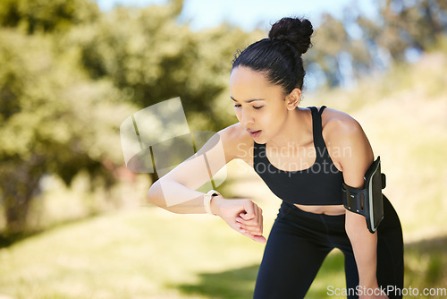 Image of Woman, fitness and checking watch in rest after running, cardio exercise or workout in nature. Fit or active female person, athlete or runner looking at wristwatch on break for monitoring performance