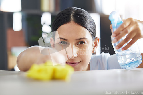 Image of Spray, table and cleaning with a woman maid using disinfectant to remove bacteria in a home. Safety, surface and hygiene with a female housekeeping cleaner working in a house living room for service