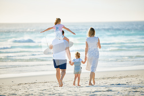 Image of Summer, holding hands and travel with family at beach for happy, vacation and bonding. Freedom, support and ocean with parents and children walking on seaside holiday for love, care and happiness