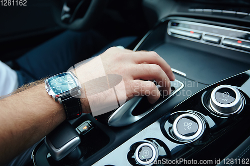 Image of hand on automatic gear shift, Man hand shifting an automatic car