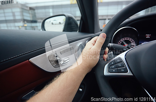 Image of Man sitting and driving in the car.