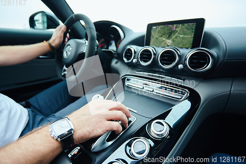 Image of hand on automatic gear shift, Man hand shifting an automatic car