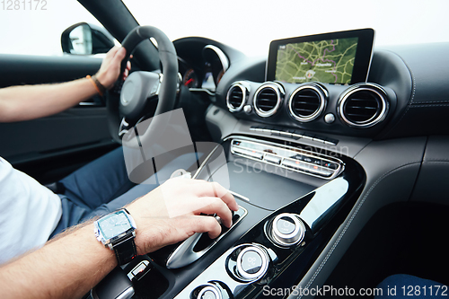 Image of hand on automatic gear shift, Man hand shifting an automatic car