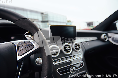 Image of Control buttons on steering wheel. Car interior.