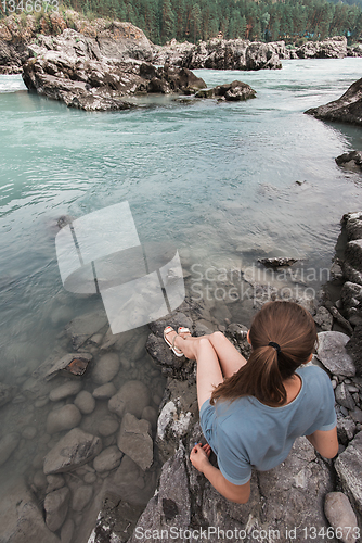 Image of Woman resting at river