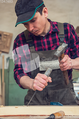 Image of Carpenter working with a chisel