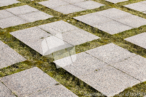 Image of old large tiles on the road