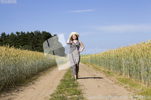 Image of young girl walking a country sandy road