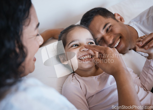 Image of Love, smile and happy family in a bed laughing, bonding and playing in their home together. Face, playful and girl child with parents in a bedroom, having fun and enjoying a weekend in their house