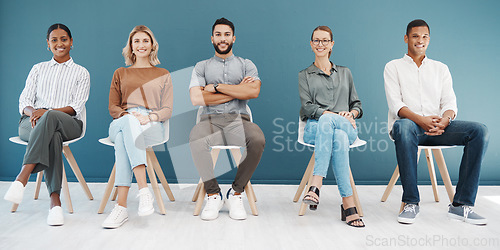 Image of Group, business people and chair portrait by wall with smile, diversity and waiting room for hr recruitment. Men, women and smile together for interview, human resources and hiring for job at startup