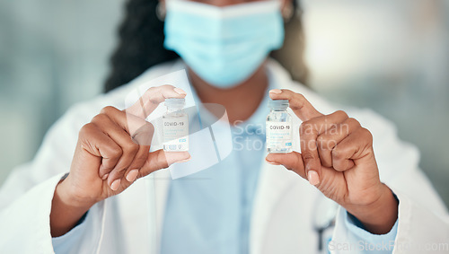 Image of Doctor hands, covid and black woman with vaccine vials for virus or corona. Bottles, medical professional and person with vaccination mask, medicine or pharmaceutical drugs for healthcare at hospital